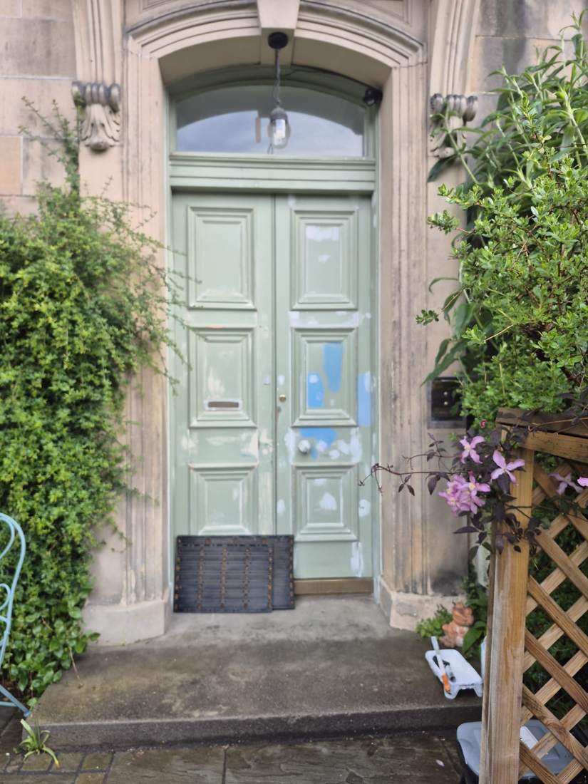 Front door before restoration: old paint filled, sanded and primed