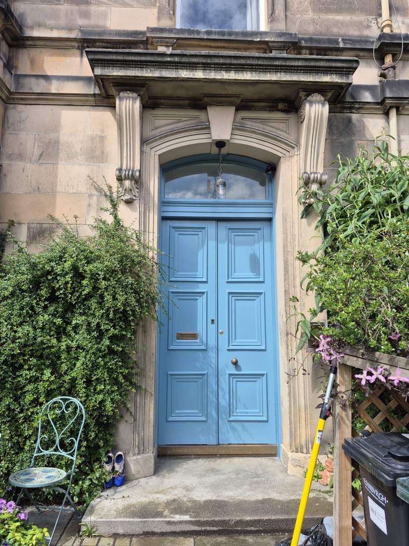 The same front door restored and repainted in a deep blue